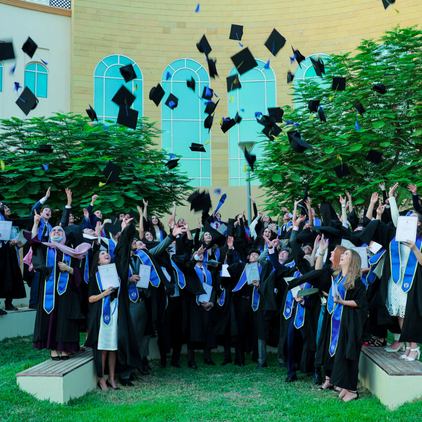 Sixth Form pupils throwing graduation hats at Brighton College Abu Dhabi 422 x 422